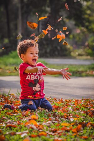 boy wearing red t shirt and blue pants