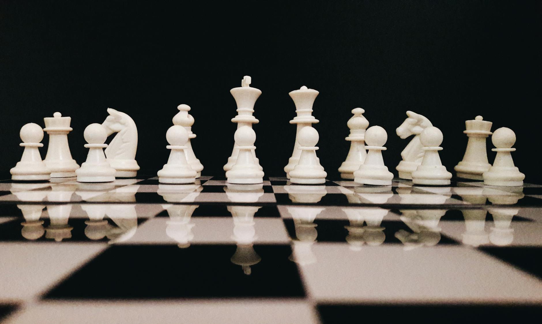 white chess piece on top of chess board